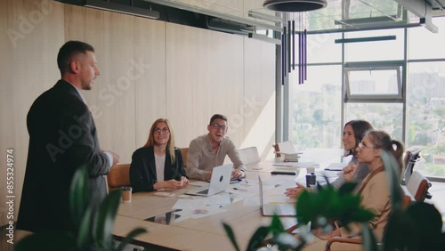 In a modern office, a team of professionals works together, brainstorming and planning. They engage in collaboration in a contemporary workspace, showing innovation and teamwork