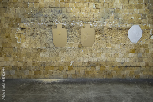 Wooden bullet catcher wall and targets in a shooting range.