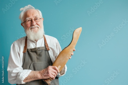 old man with a white beard. shoemaker work with leather. tailor photo