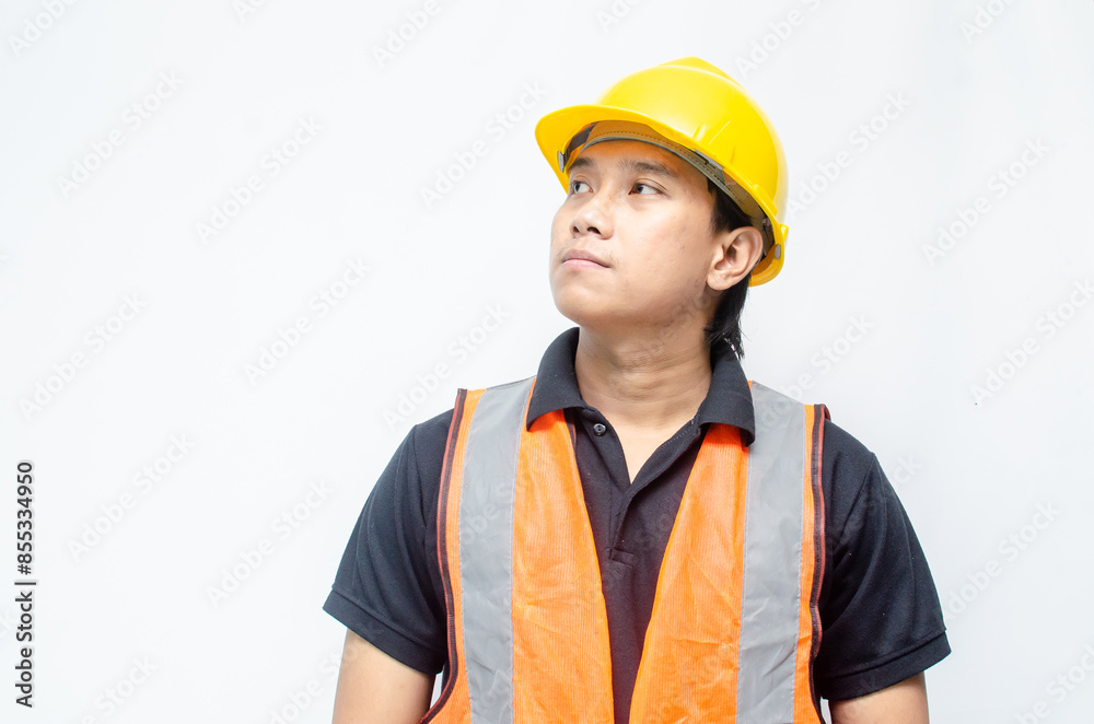 Portrait of an Asian young confident construction worker or engineer standing and looking up to show a bright future over a white background. bright future worker concept. Portrait of an Asian young confident construction worker or engineer standing and looking up to show a bright future over a white background. bright future worker concept.