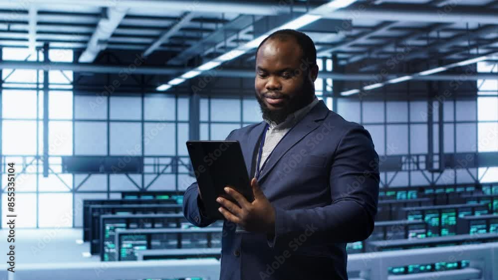 Software engineer in data center runs error checking utilities on tablet to fix problems. IT specialist looking for network issues affecting rigs performance using digital device, camera A Software engineer in data center runs error checking utilities on tablet to fix problems. IT specialist looking for network issues affecting rigs performance using digital device, camera A