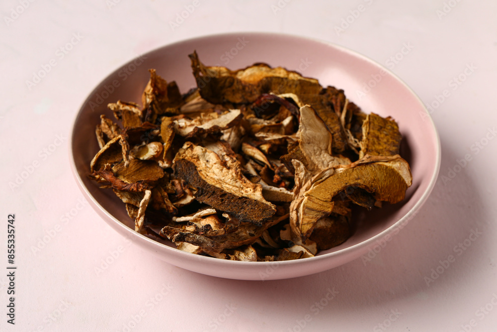 Bowl with tasty dried mushrooms on white background Bowl with tasty dried mushrooms on white background