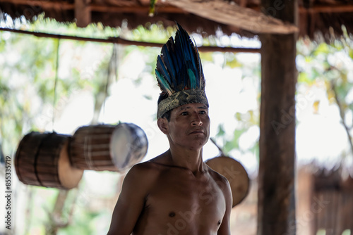 Wayuri indigenous man posing with traditional drums in the Ecuadorian Amazon photo