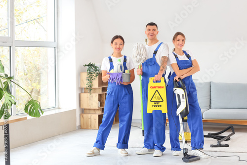 Team of young janitors with...