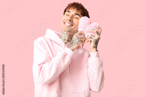 Happy young man in pink hoo...