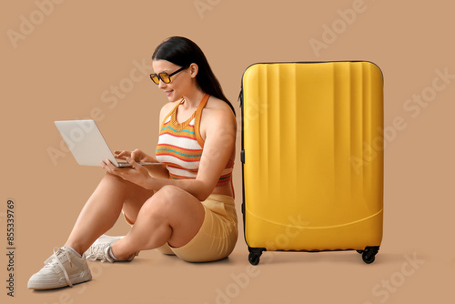 Young woman using laptop wh...