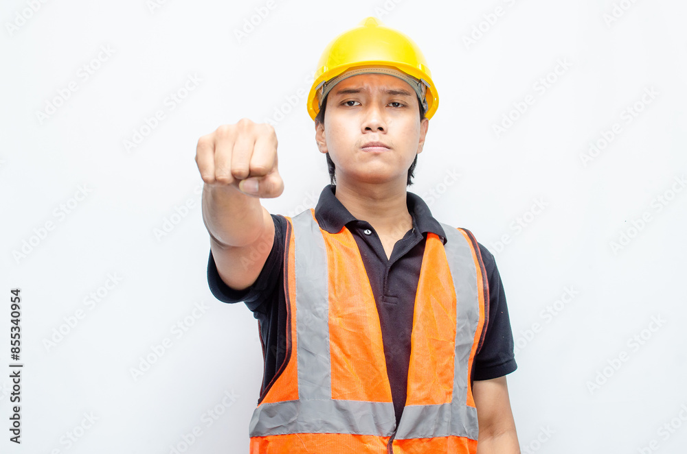Asian male construction worker in a safety helmet and orang vest doing protest, rejecting and refusing something. labour day concept. Asian male construction worker in a safety helmet and orang vest doing protest, rejecting and refusing something. labour day concept.