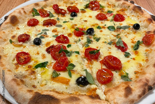 Pizza with Mozzarella, tomatoes and olives