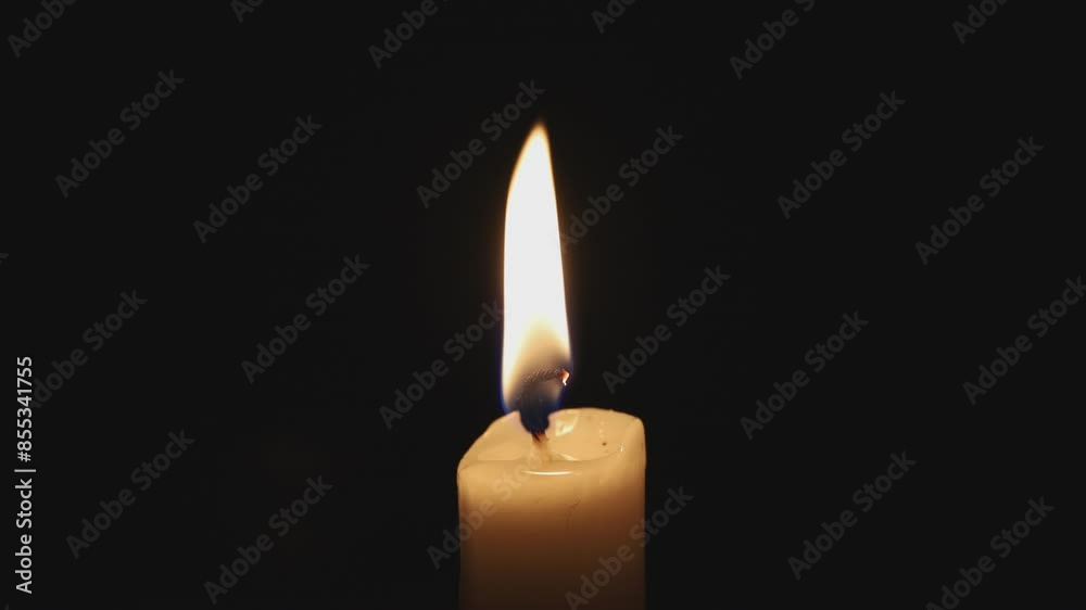 Paraffin candle in complete darkness, light wind Paraffin candle in complete darkness, light wind