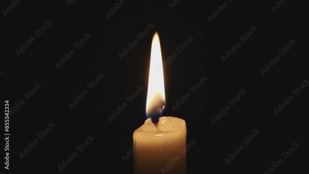 Paraffin candle in complete darkness, light wind Paraffin candle in complete darkness, light wind