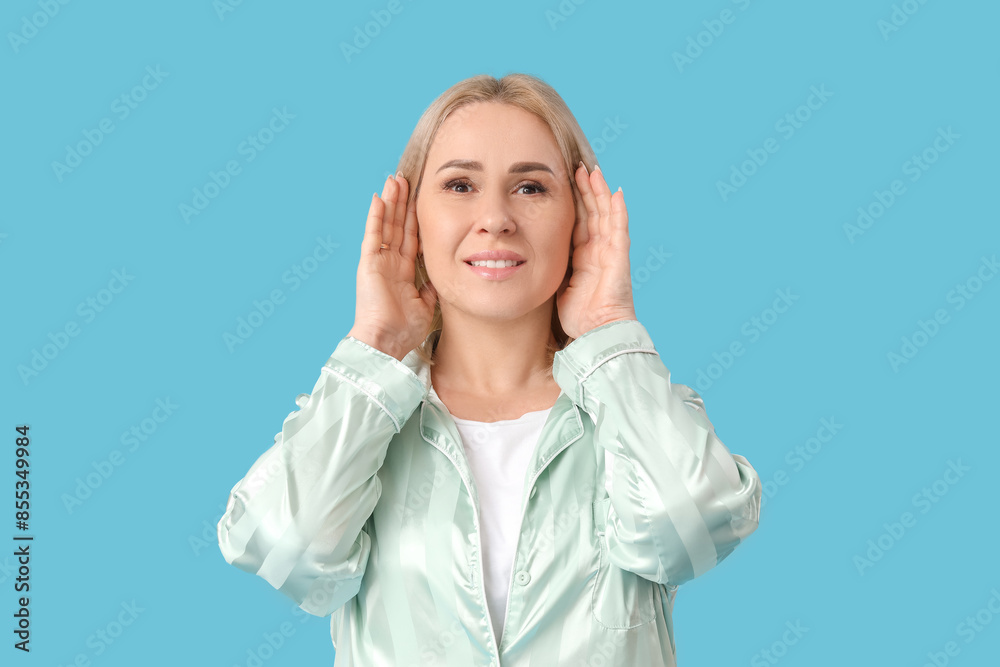 Beautiful mature happy woman with healthy skin on blue background Beautiful mature happy woman with healthy skin on blue background