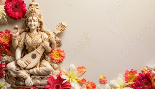 Statue of Goddess Saraswati with veena surrounded by fresh flowers on empty background.