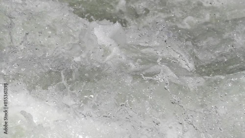 Close-up of the splash of the torrent. 1/4 slow-speed live-action video. photo