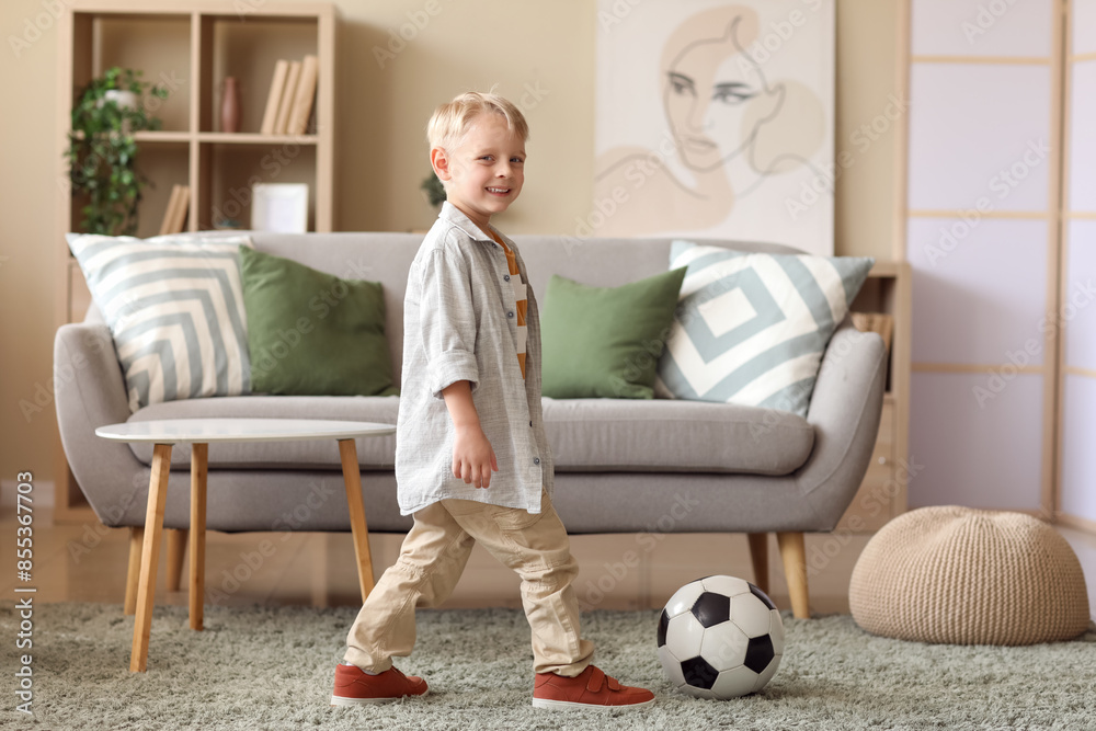 Cute little football player with soccer ball at home Cute little football player with soccer ball at home