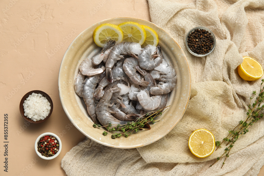 Bowl with fresh raw shrimps and lemon on beige background Bowl with fresh raw shrimps and lemon on beige background