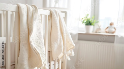 Muslin baby blanket hanging on childs bed in nursing room : Generative AI
