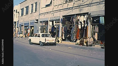 Haifa, ISRAEL - CIRCA 1979: Haifa Israeli port city by the Mediterranean sea. Shops on the street with traditional clothes and handmade furniture. Historical archival footage in the 1970s of Israel. photo