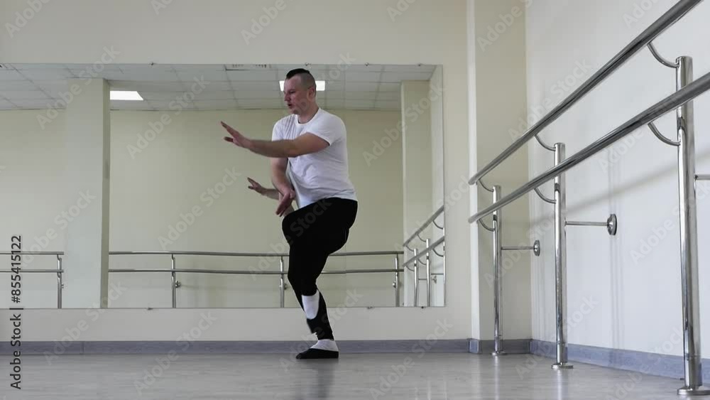 Professional classical ballet, warming up during training. A ballerina dancer warms up on a ballet barre. Young man in ballet shoes rehearsing in the hall. Professional classical ballet, warming up during training. A ballerina dancer warms up on a ballet barre. Young man in ballet shoes rehearsing in the hall.