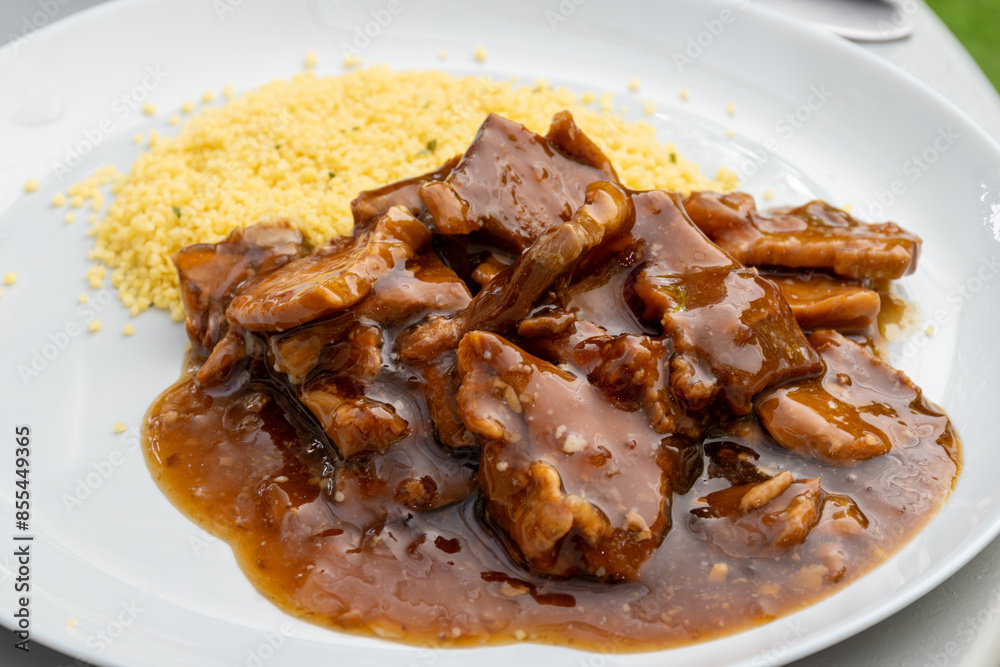 Meat dish Caramel pork served with couscous Meat dish Caramel pork served with couscous