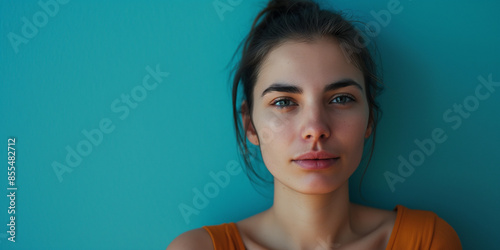 Serious woman portrait on bright blue background, a natural portrait of a woman expressing serious