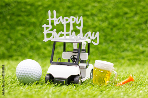 Golf birthday theme on green grass with golf ball and tee celebration concept