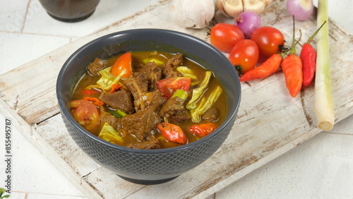 Tongseng kambing is an Indonesian goat meat, mutton or beef stew dish in curry-like soup, with vegetables and sweet soy sauce. photo