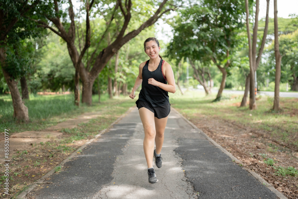 Asian woman running in the park. Exercise concept for health. Body care and weight loss.