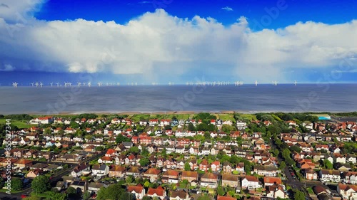 Looming storm over the seaside town of Skegness. English Holiday reasort showing caravan sites and hotels with stormy sky’s over the ocean. British Coastal scene with bad summer weather. photo