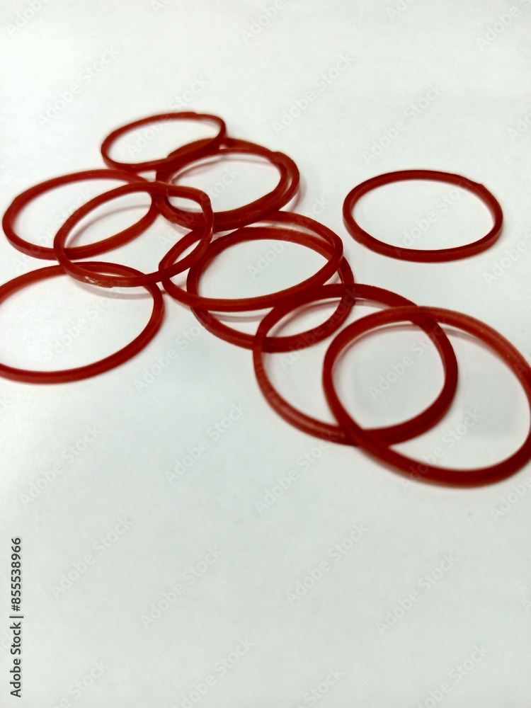 Several red rubber bands on a white background. Several red rubber bands on a white background.