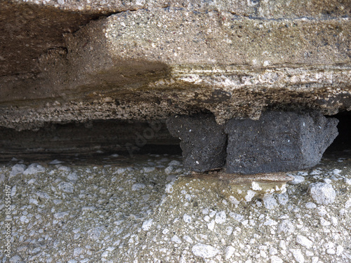 Stone stuck between to geological layers in rock cleft photo