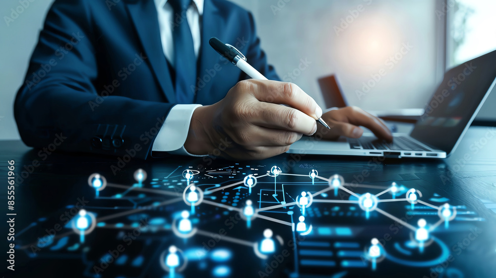 A businessman uses a stylus on a laptop, with a network of connected icons overlayed, representing communication and collaboration. A businessman uses a stylus on a laptop, with a network of connected icons overlayed, representing communication and collaboration.