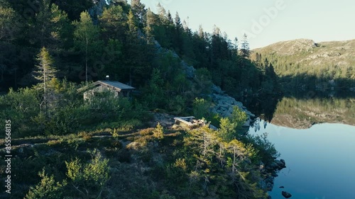 Mjøvatnet, Indre Fosen, Trøndelag, Norway - A Cozy Wooden Cabin Situated by the Lake - Orbit Drone Shot photo