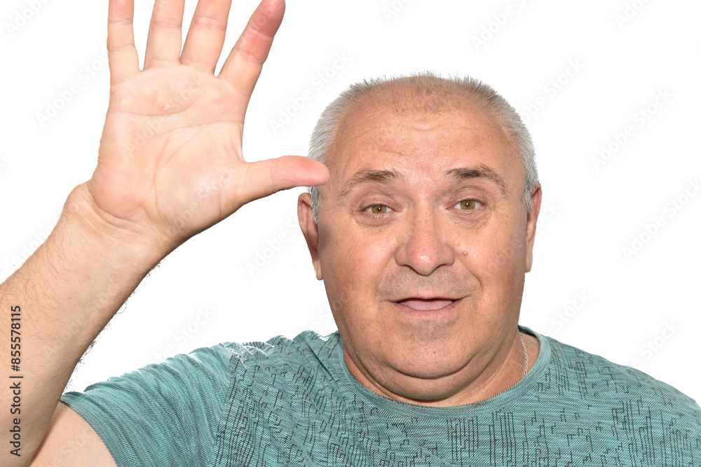 Portrait of an elderly man greeting someone by raising his hand. Portrait of an elderly man greeting someone by raising his hand.