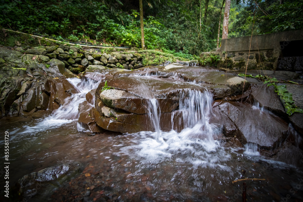 Obraz premium Small river in the salak mountain forest area of ​​Bogor, West Java, Indonesia. Long exposure photo.