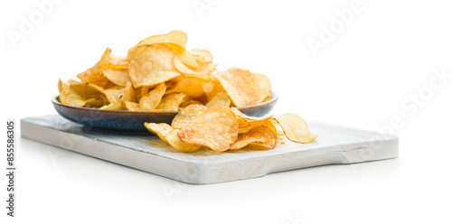 Close Up of Crispy Potato Chips on cutting board  isolated on White Background