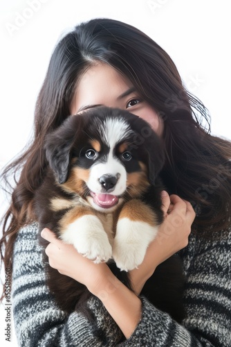 Pretty young women super models of Japanese ethnicity holding Bernese Mountain Dog puppy with expressive expression, no crop head. photo on white isolated background