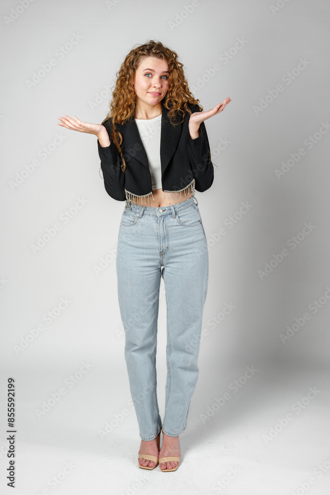 Young Curly Clueless Woman Holding Out Hands Young Curly Clueless Woman Holding Out Hands