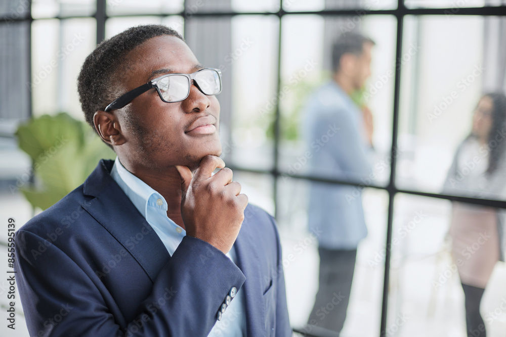 Head shot close up young thoughtful african american businessman entrepreneur looking away.
