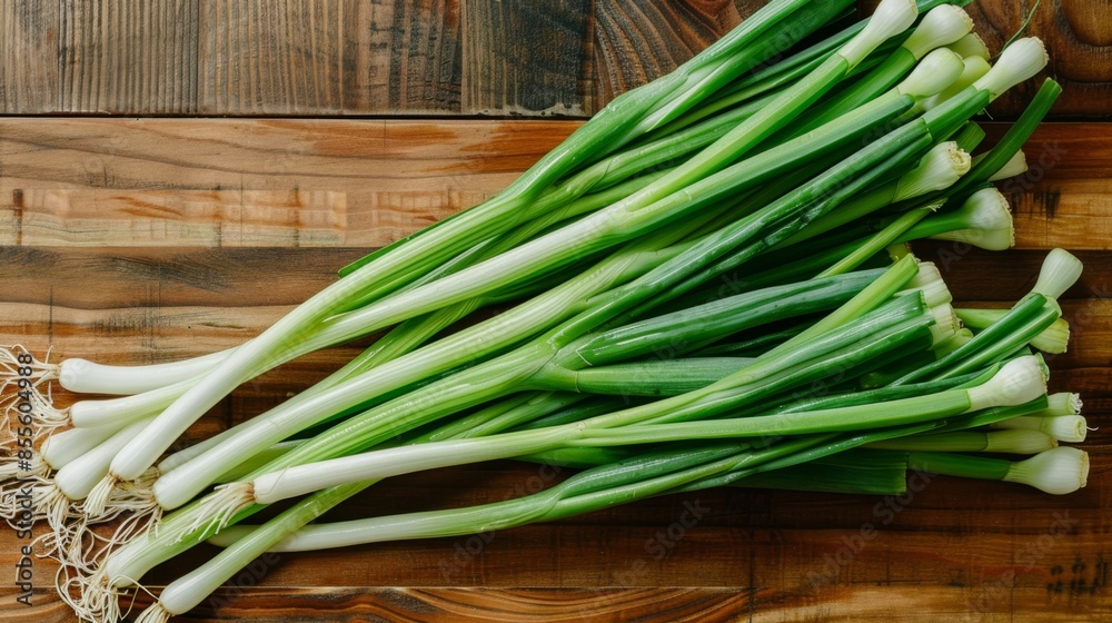 Bunch of fresh green onions on a wooden cutting board. Bunch of fresh green onions on a wooden cutting board.