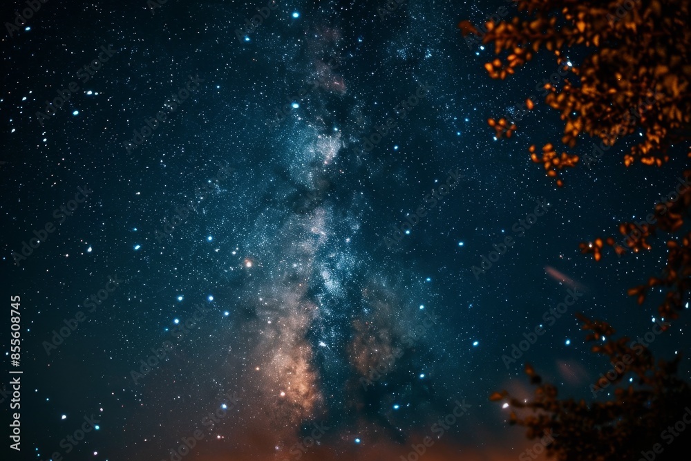 Obraz premium A view of a dark night sky showcasing numerous stars and the Milky Way galaxy, A starry night sky with the Milky Way stretching across it