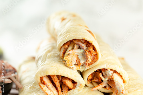  shawarma rolls, Eastern Arab food, served with tahini and onions with sumac. photo