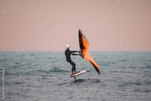 Fotografie Wing Surfing or WingFoiling During a Windy Day