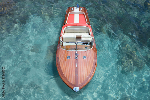 Boat with American flag Riva Aquarama top view. Exclusive expensive wooden boat Riva Aquarama on azure water, top view. Riva boat aerial view.