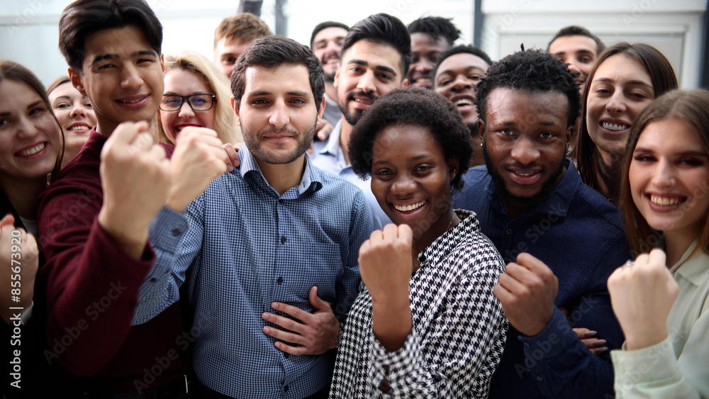 Confident diverse college students show fist up. Confident diverse college students show fist up.