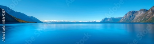 serene mountain lake landscape with clear blue sky and tranquil water.