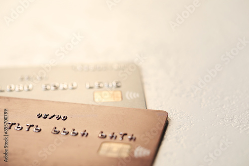 Two credit cards on gray background, closeup. Space for text