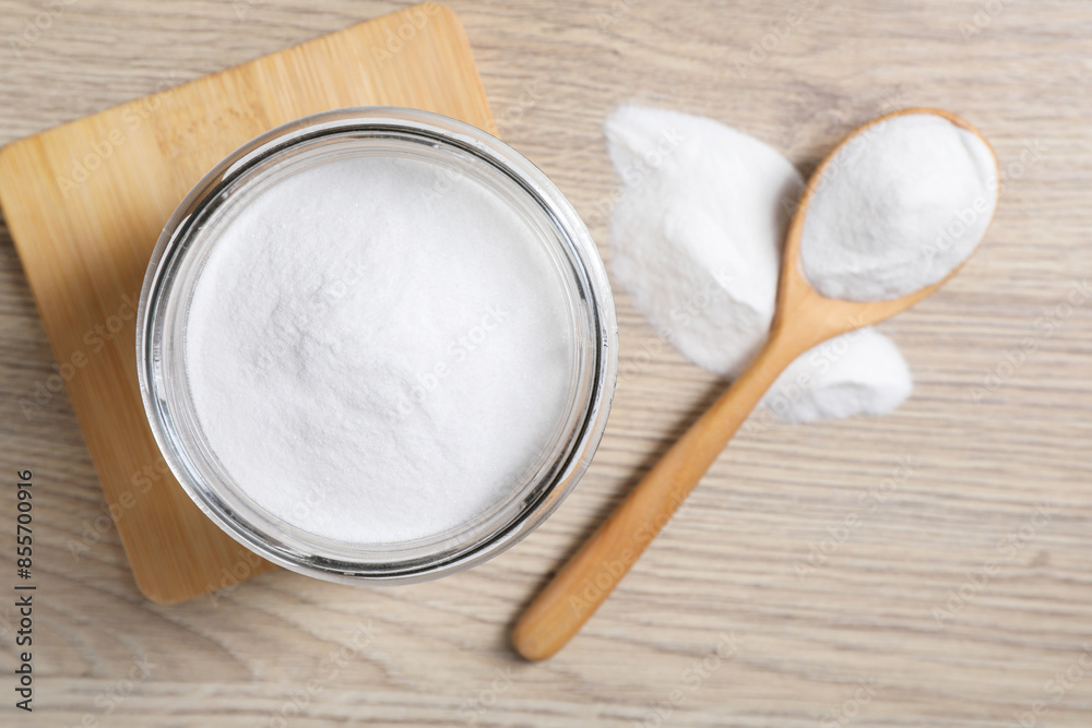 Baking soda in glass jar on wooden table, top view Baking soda in glass jar on wooden table, top view