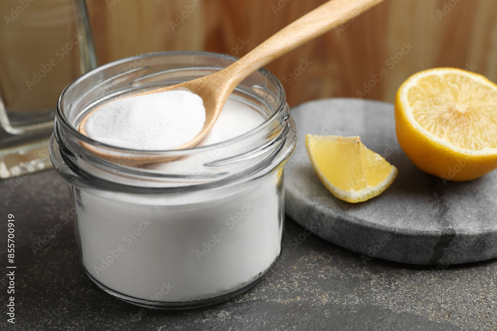 Baking soda and lemon on grey table, closeup Baking soda and lemon on grey table, closeup