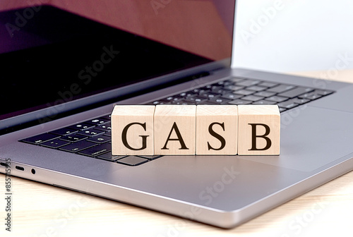 GASB word on wooden block on a laptop , business concept photo