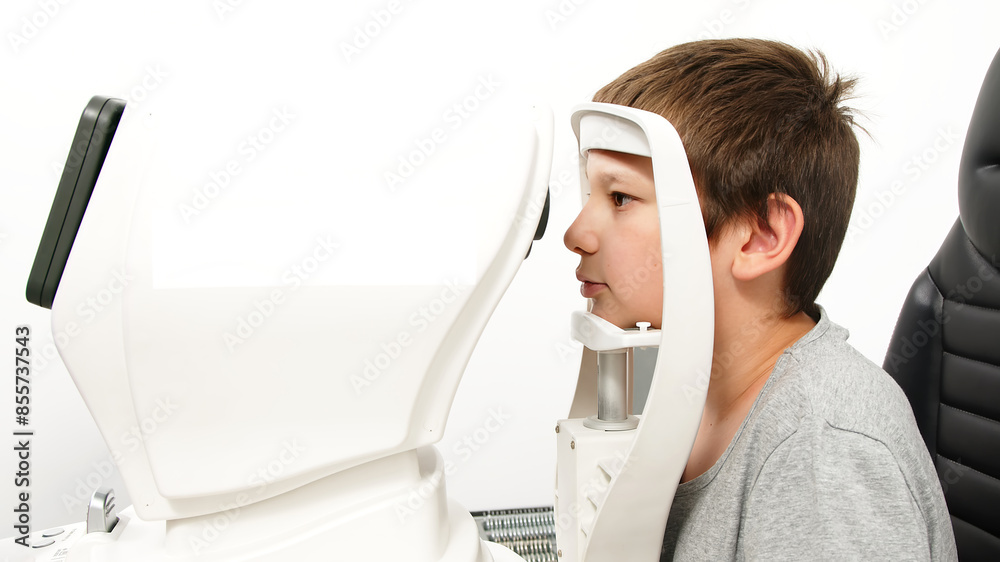 An ophthalmologist does an eye examination, working in a modern clinic with professional equipment. A girl checks a child's eyesight. An ophthalmologist does an eye examination, working in a modern clinic with professional equipment. A girl checks a child's eyesight.